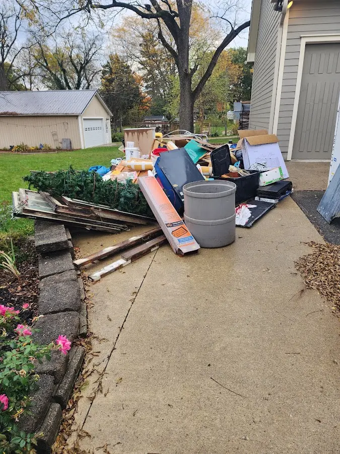 Dumpster being loaded with debris for Commercial Dumpster Rental in Brooks
